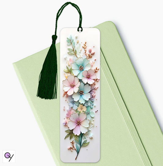 Small and large pastel coloiur £D flowers on a white background. This bookmark gift is sitting on a mint green diary, upon a white background.