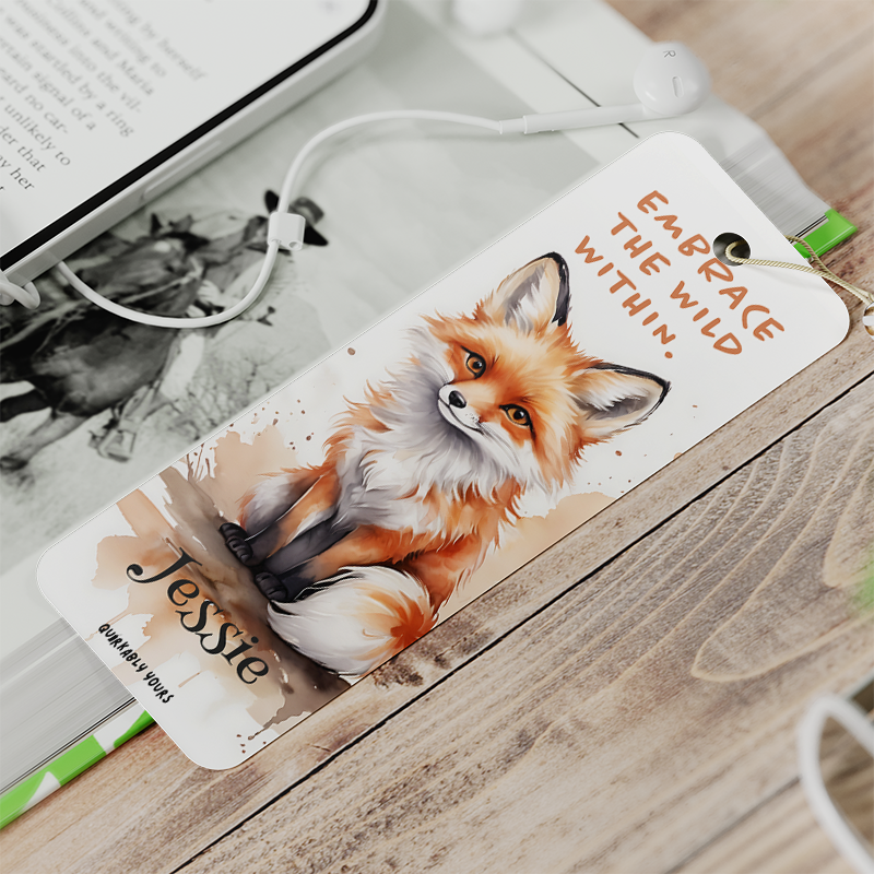 Bookmark with a fox illustration and motivational quote on a wooden surface
