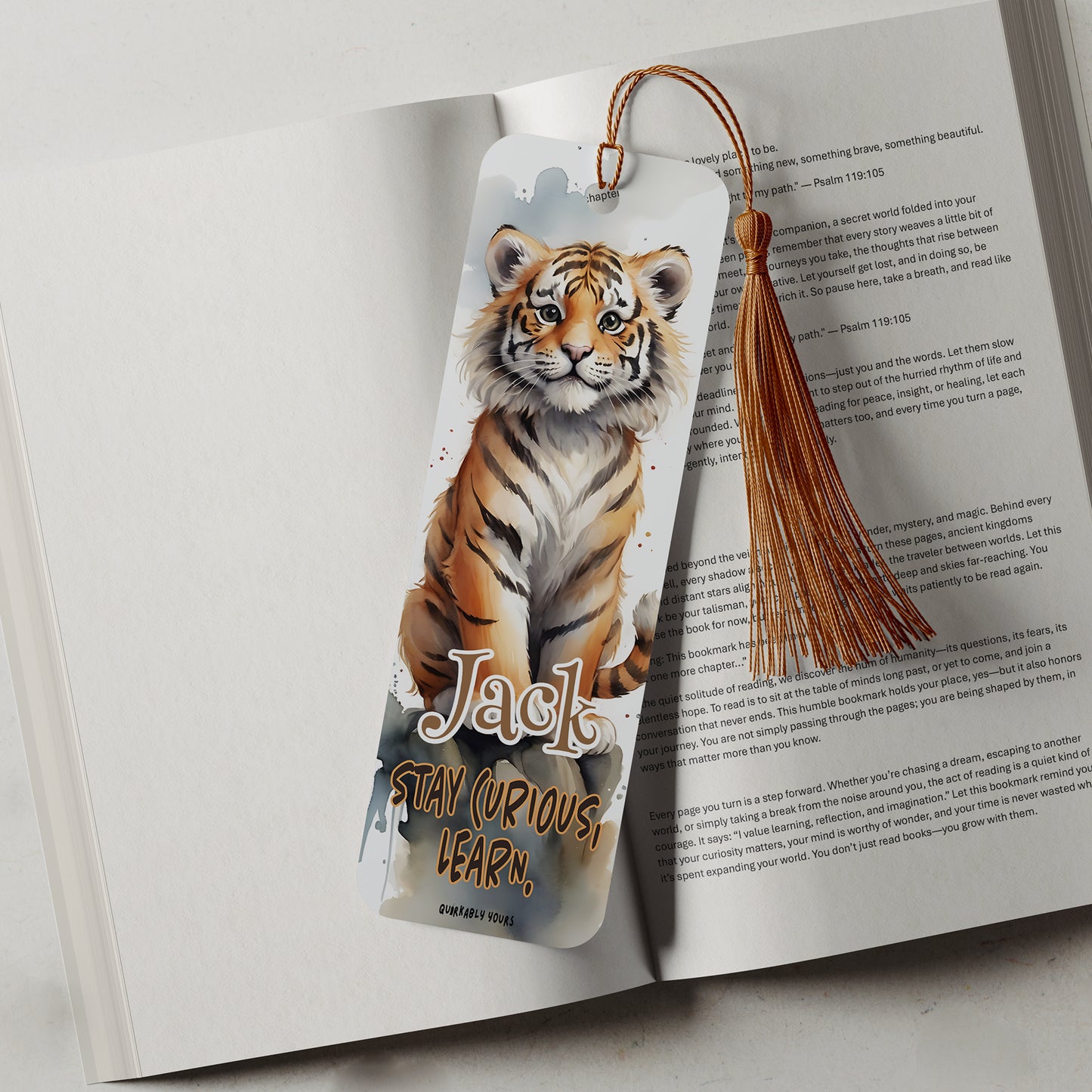 Bookmark with a tiger design on an open book with a motivational quote