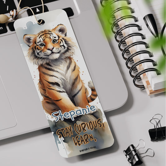 Bookmark with a tiger design and text on a desk with office supplies