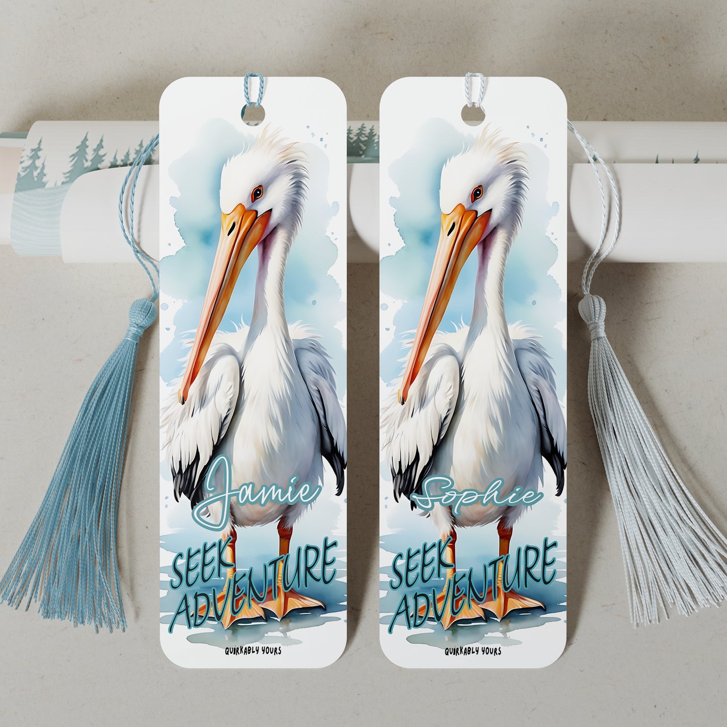 Two bookmarks with pelican illustrations and personalized names on a light grey background with an inspirational quote