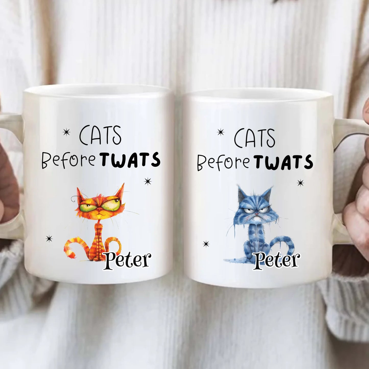 Two mugs with cartoon cats and text 'Cats Before Twats Peter' held by two people.