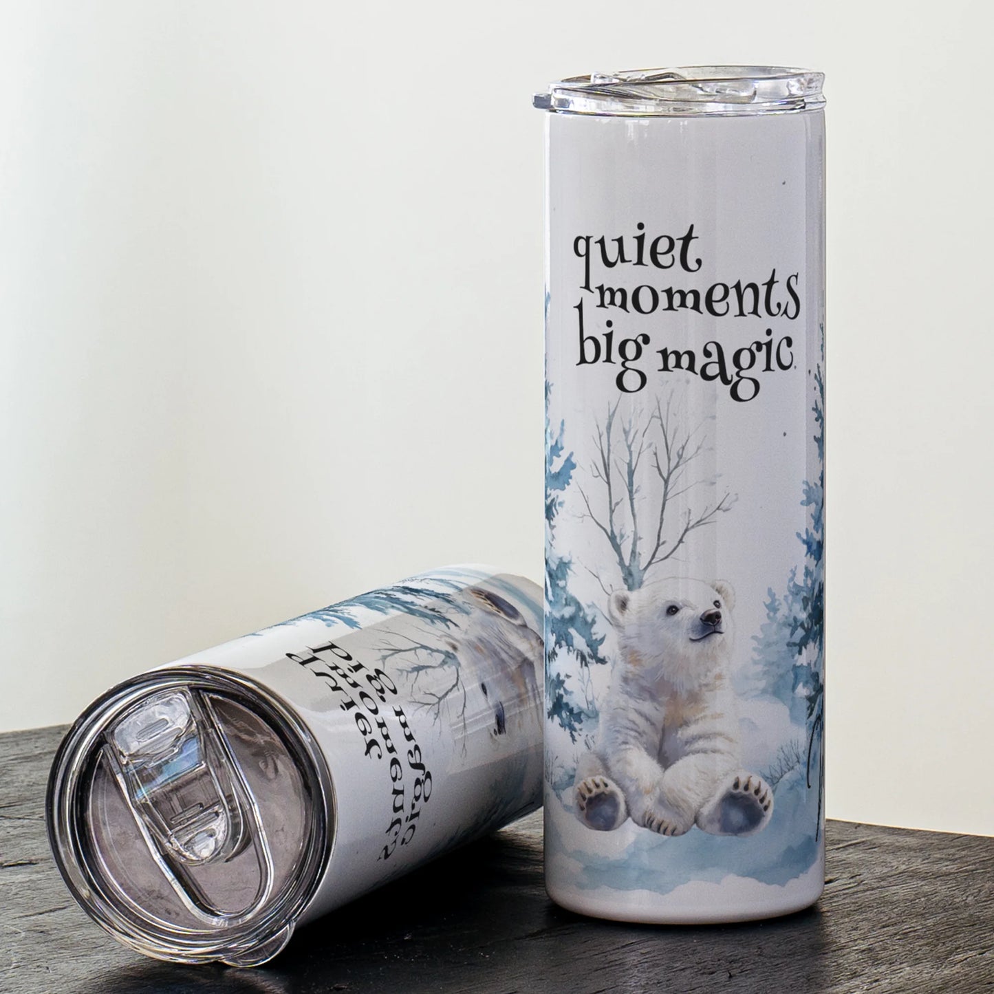 Tumbler with polar bear design and 'quiet moments big magic' text on a white background