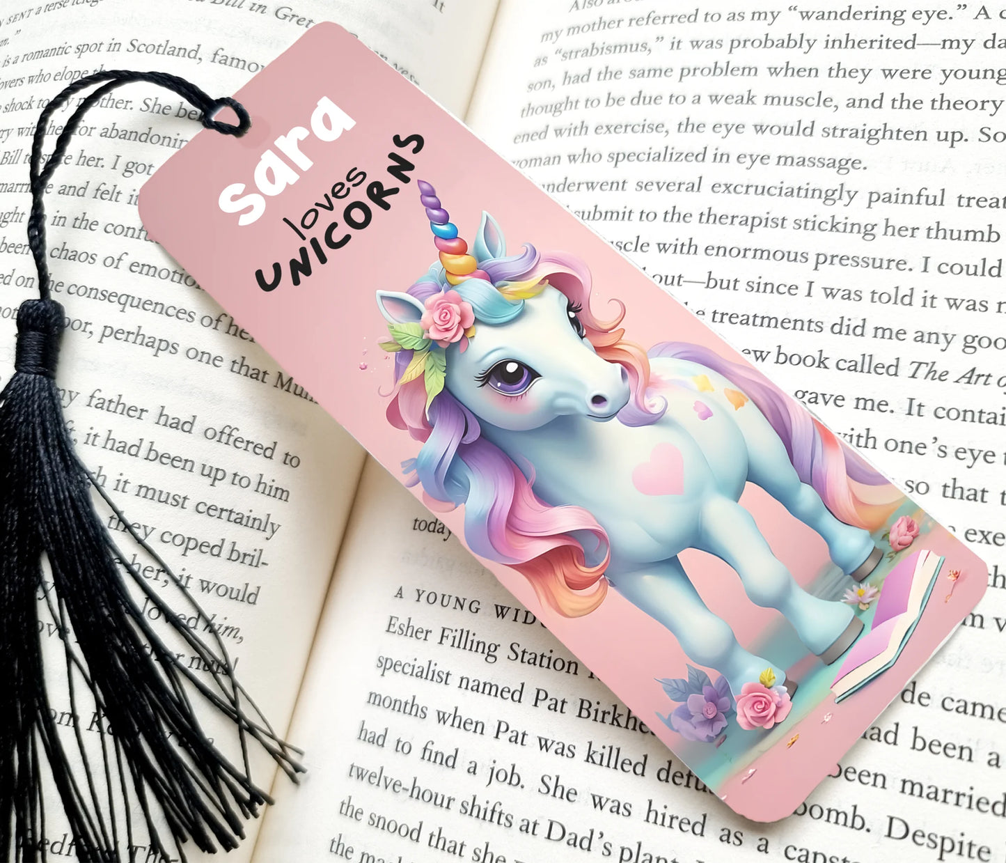 Unicorn-themed bookmark with tassel on an open book
