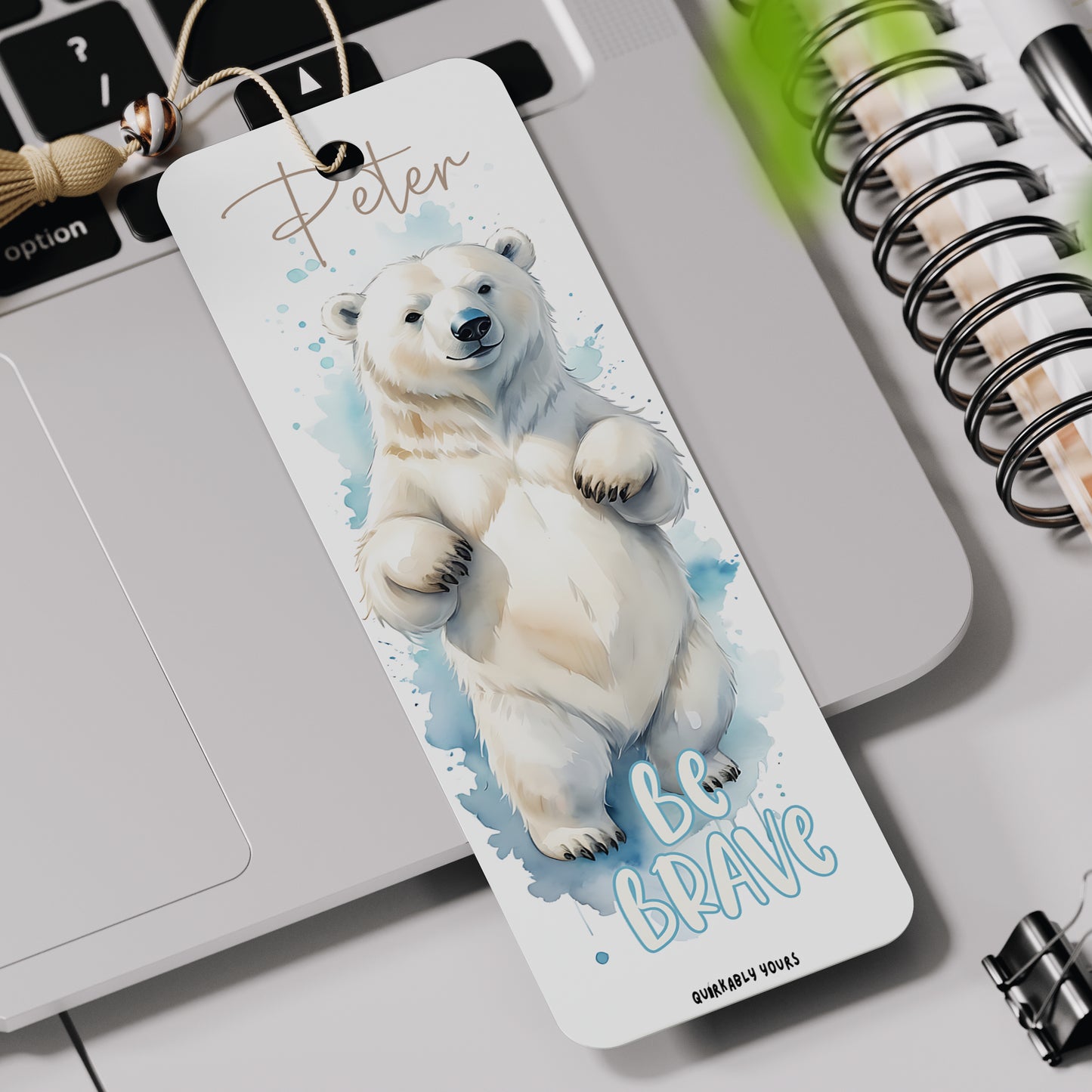 Bookmark with a polar bear and 'Be Brave' text on a desk with stationery items. Personalised gift