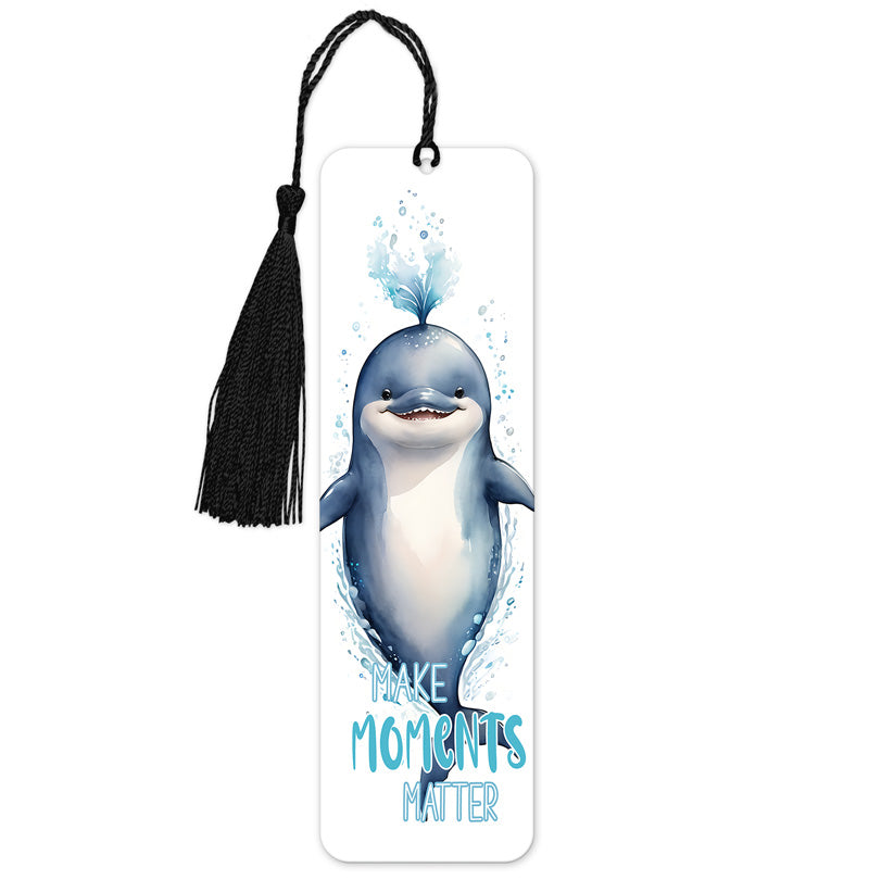 A colorful bookmark featuring a whale with the phrase 'Make Moments Matter' printed below it. It includes a black tassel at the bottom.