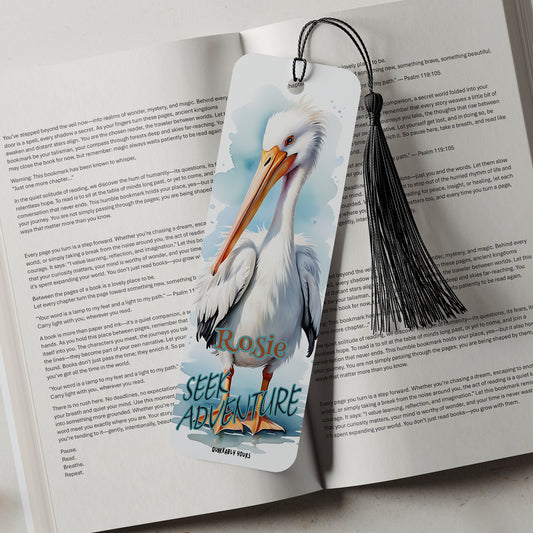 Bookmark with a pelican design on an open book with a motivational quote
