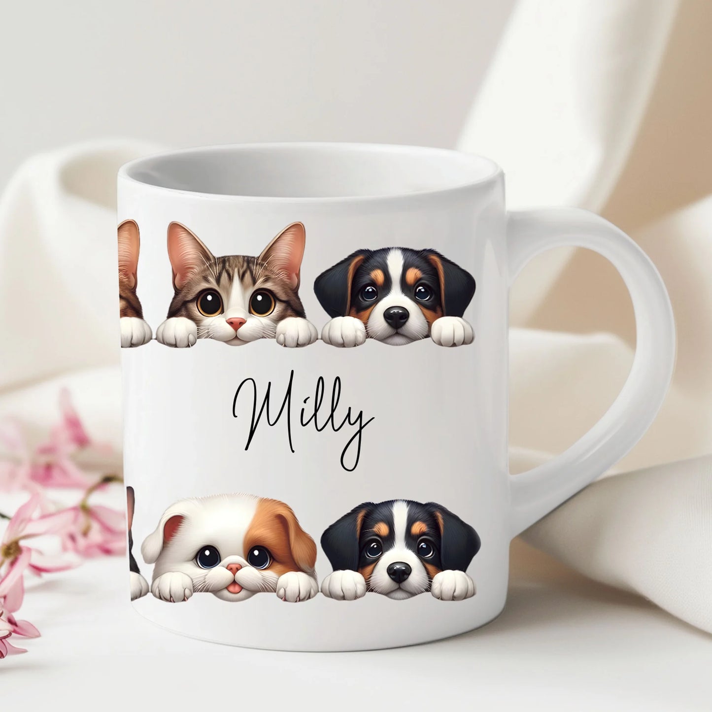 White mug with illustrations of a cat, two dogs, and the name 'Milly' on a light background.