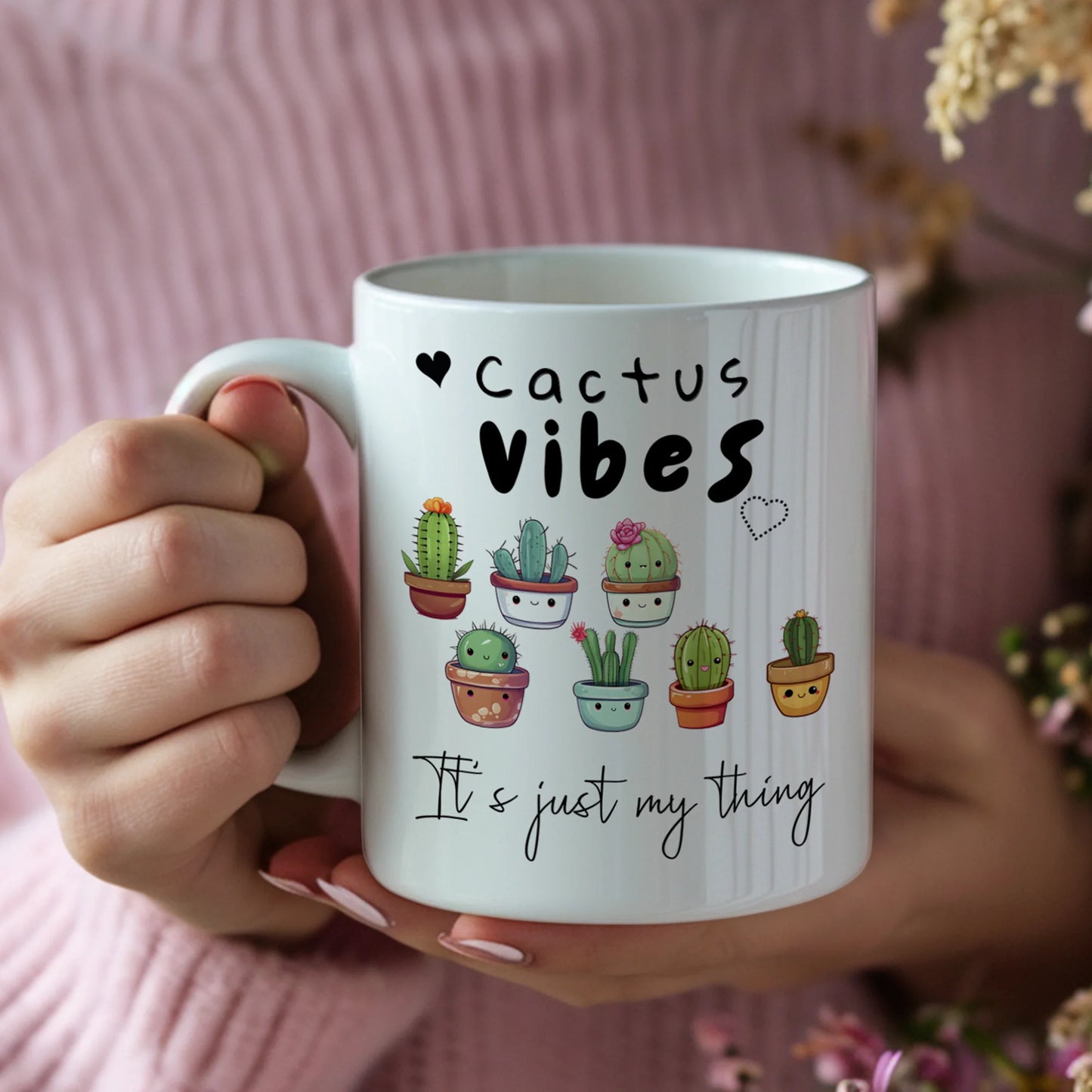 Mug with 'Cactus Vibes, It's just my thing' text and cactus illustrations held by a person.