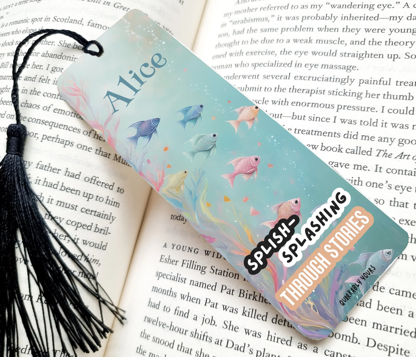 Bookmark with fish illustrations and 'Splish Splashing Through Stories' text on an open book.