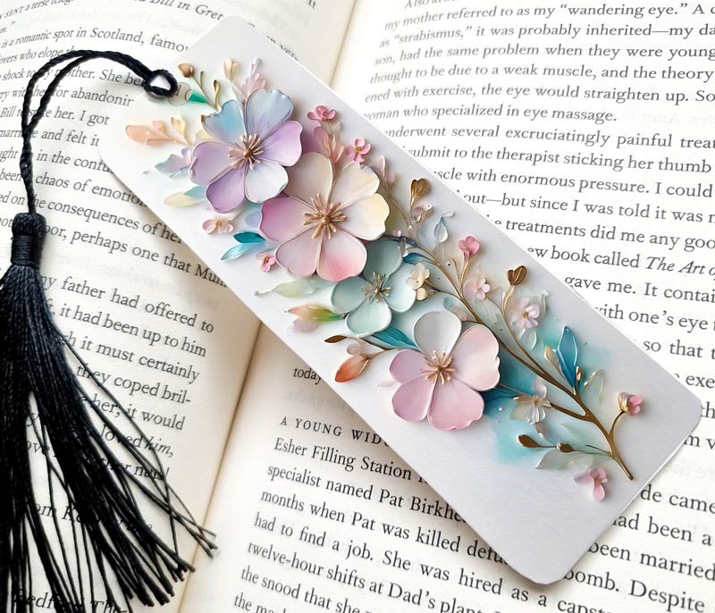 3D flowers Bookmark on a background,  Modern and Pretty Design.  A black Tassel.  The bookmark Gift is on a open book full of writing