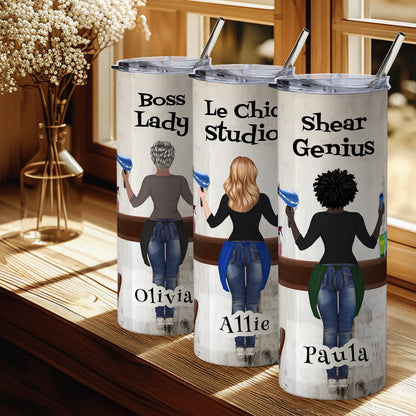 Three insulated tumblers with personalized designs and names on a wooden surface.