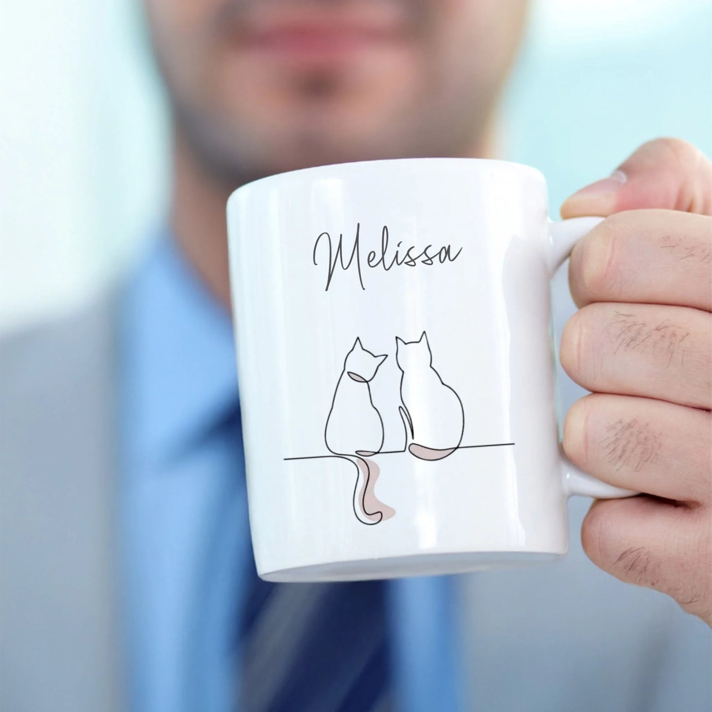 A man holding a personalised mug for the gift sets
