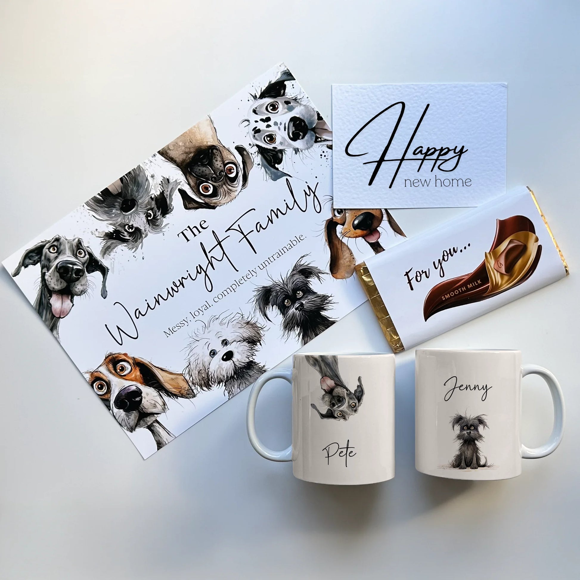 Gift set with mugs, custom personalised family print, and a chocolate bar featuring dog illustrations on a light background.