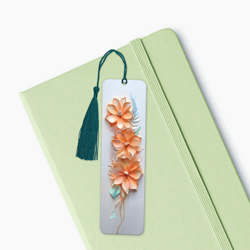 Orange and White Floral 3D Bookmark, 15 x 4.5 cm, with a orange tassel, laying on a diary. An elegant present and gift for special occasions.