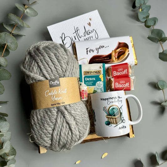 Gift set with yarn, mug, and snacks for crocheters gifts and knitter gifts