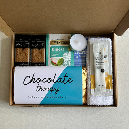 Thinking of you gift box containing a variety of items including chocolate, tea, and skincare products.