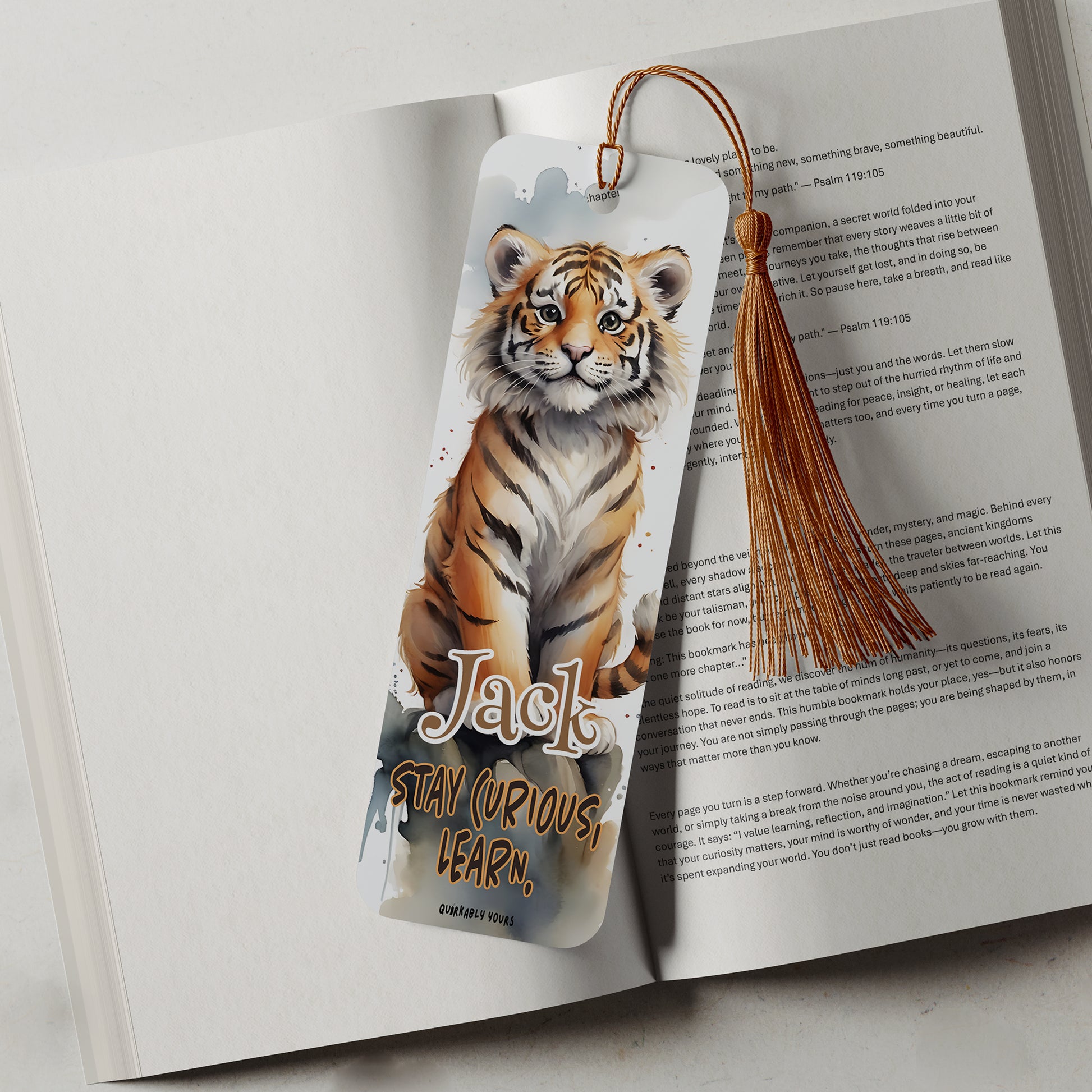Bookmark with a tiger design on an open book with a motivational quote