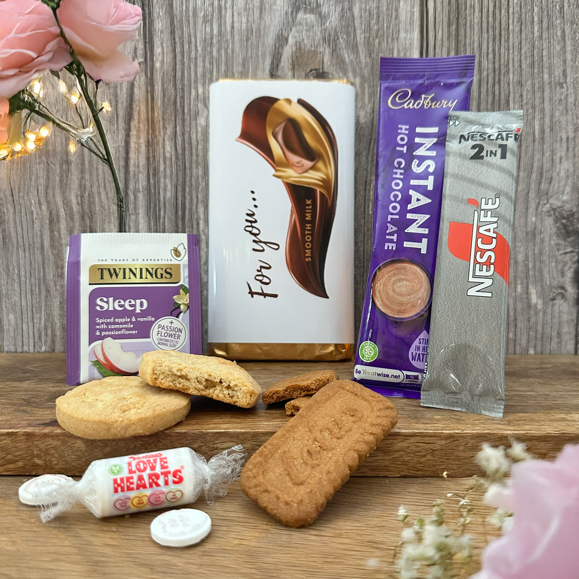 Assorted snacks and drinks including cookies, candy, and hot chocolate gift set add-on