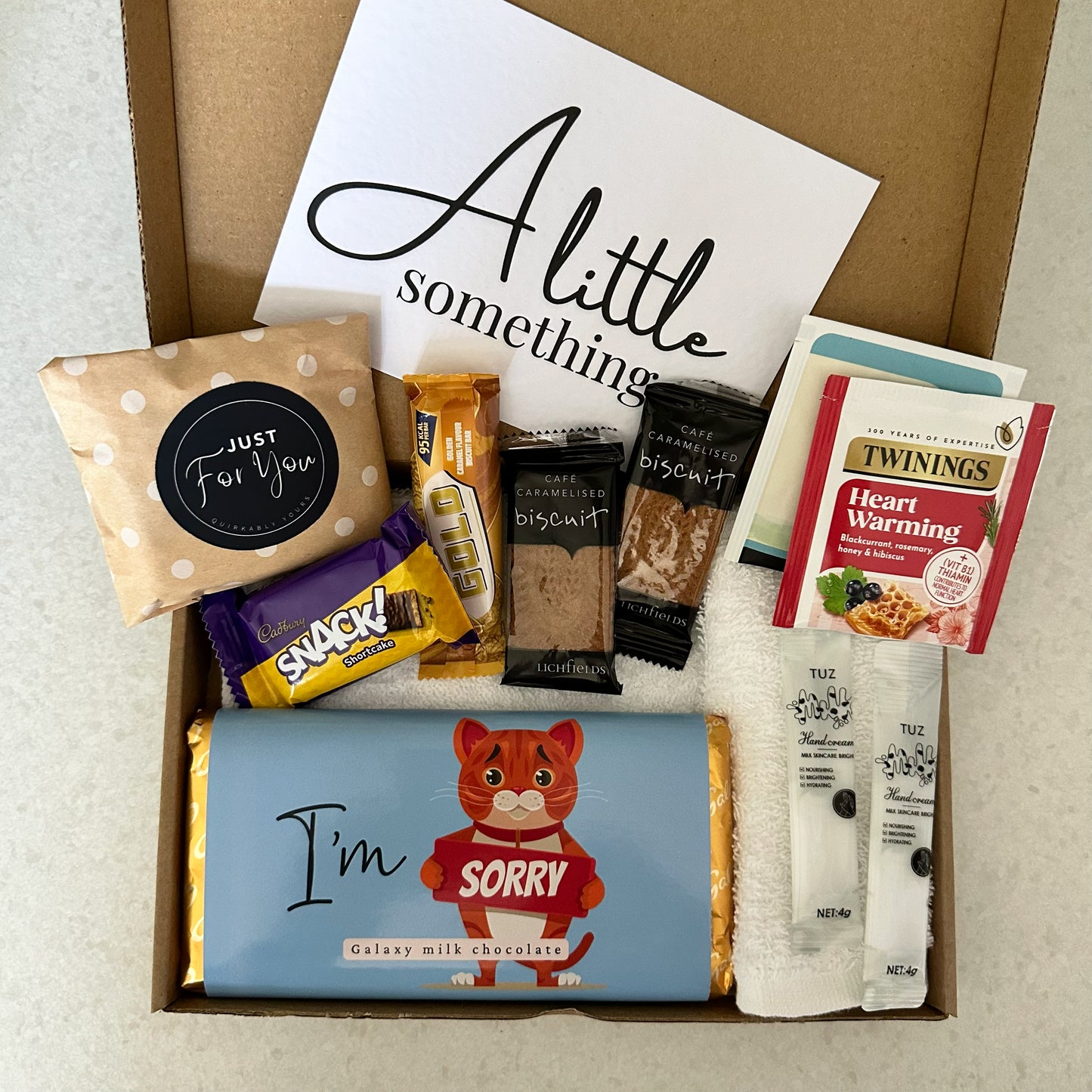 Apology letterbox gift box UK with treats and self care items