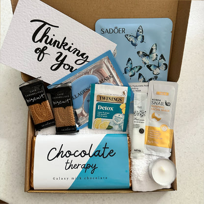 Pick me up present with chocolate treats and pamper items
