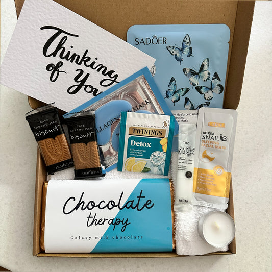 Pick me up present with chocolate treats and pamper items