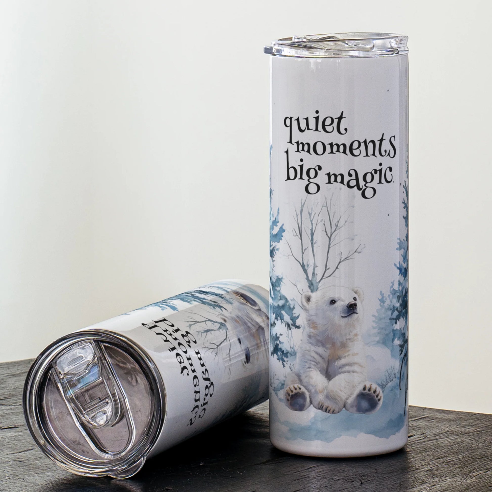 Tumbler with polar bear design and 'quiet moments big magic' text on a white background