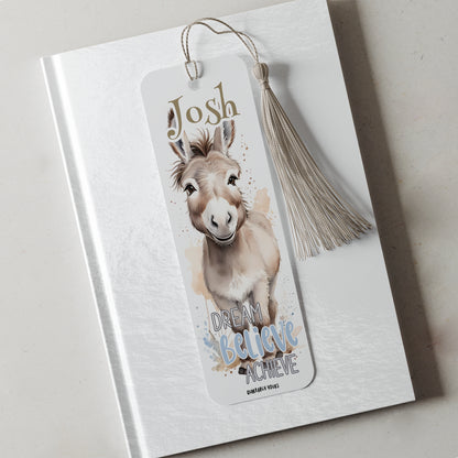 Bookmark with a donkey illustration and motivational text on a white surface