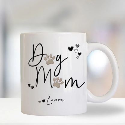 White mug with 'Dog Mum' text and paw prints on a blurred background