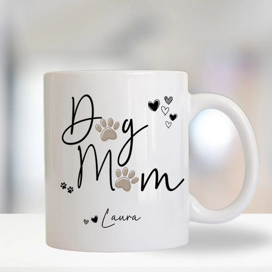 White mug with 'Dog Mum' text and paw prints on a blurred background
