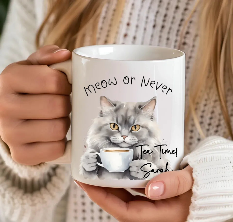 Grey tabby cat drinking tea mug