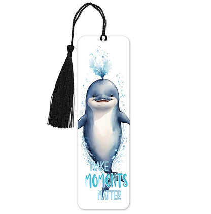 A colorful bookmark featuring a whale with the phrase 'Make Moments Matter' printed below it. It includes a black tassel at the bottom.