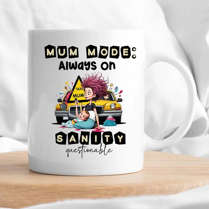 White mug with a graphic design of a mother and child, a taxi, and text 'Mum mode: Always on Sanity questionable' on a white background.