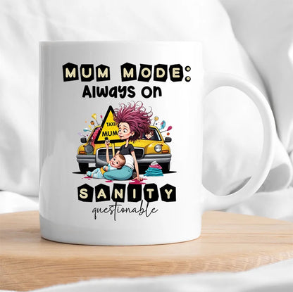 White mug with a graphic design of a mother and child, a taxi, and text 'Mum mode: Always on Sanity questionable' on a white background.