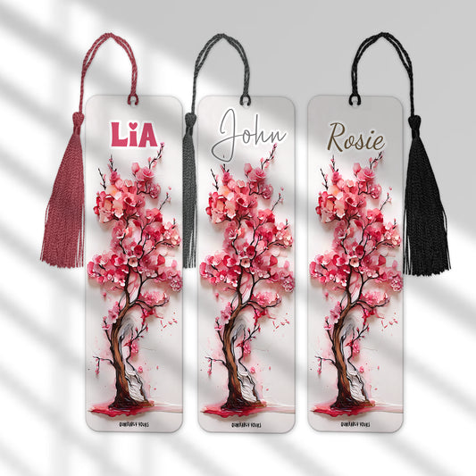 Three cherry blossom bookmarks with personalised names on a grey background