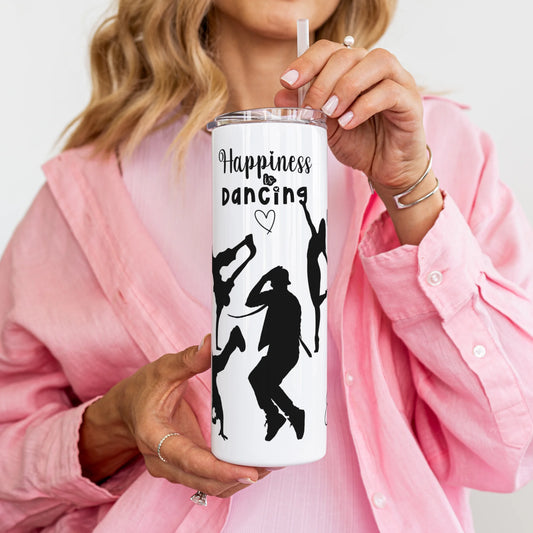 Person holding a white tumbler with dancing silhouettes and 'Happiness is dancing' text.