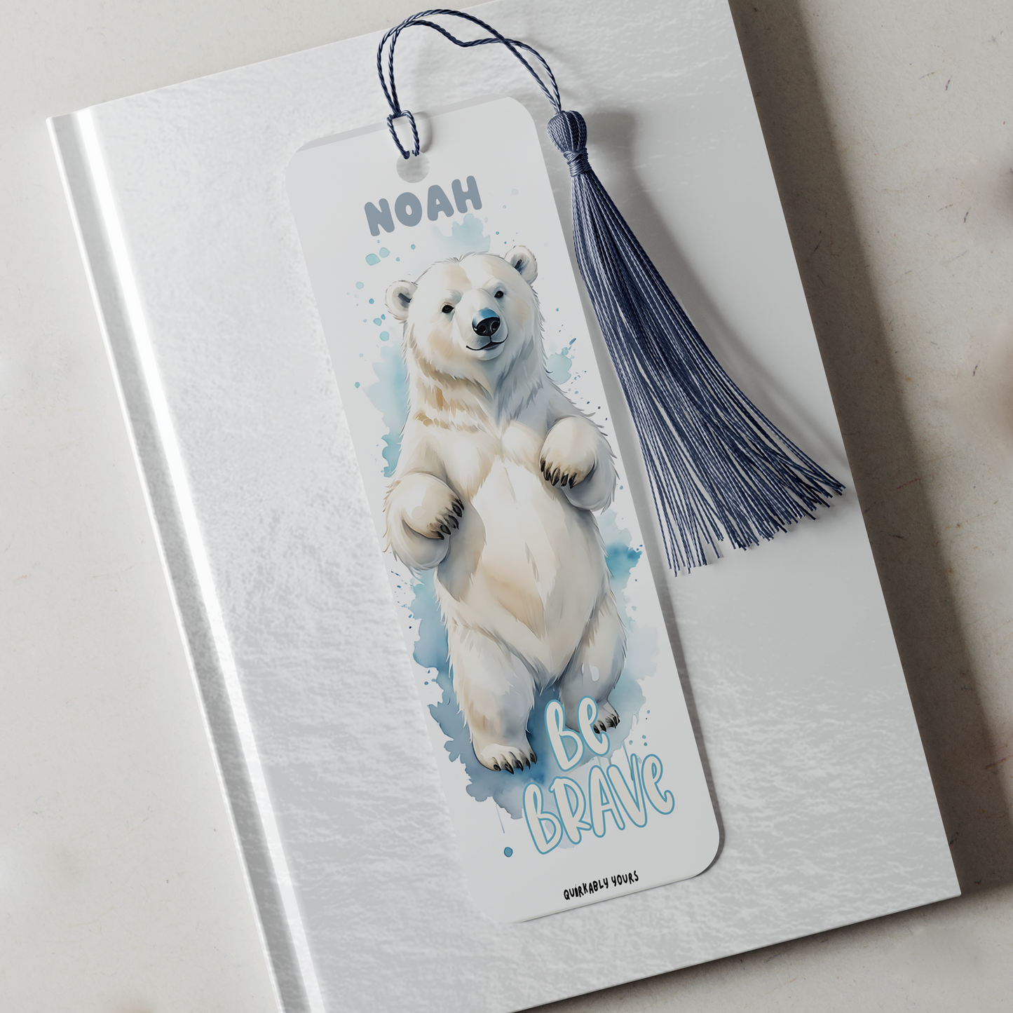 Bookmark with polar bear illustration and 'Be Brave' text on a notebook