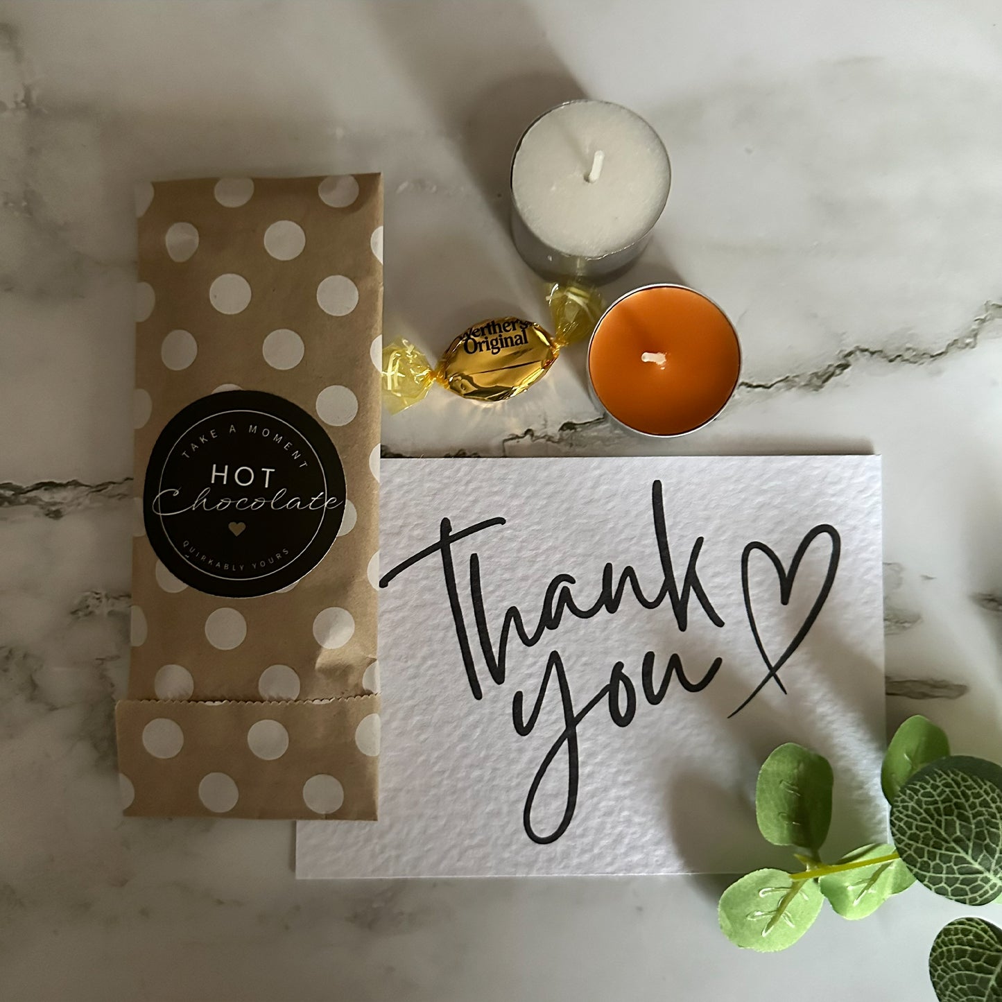 Hot chocolate package, candles, and 'thank you' card orange and brown thank you gift packaging
