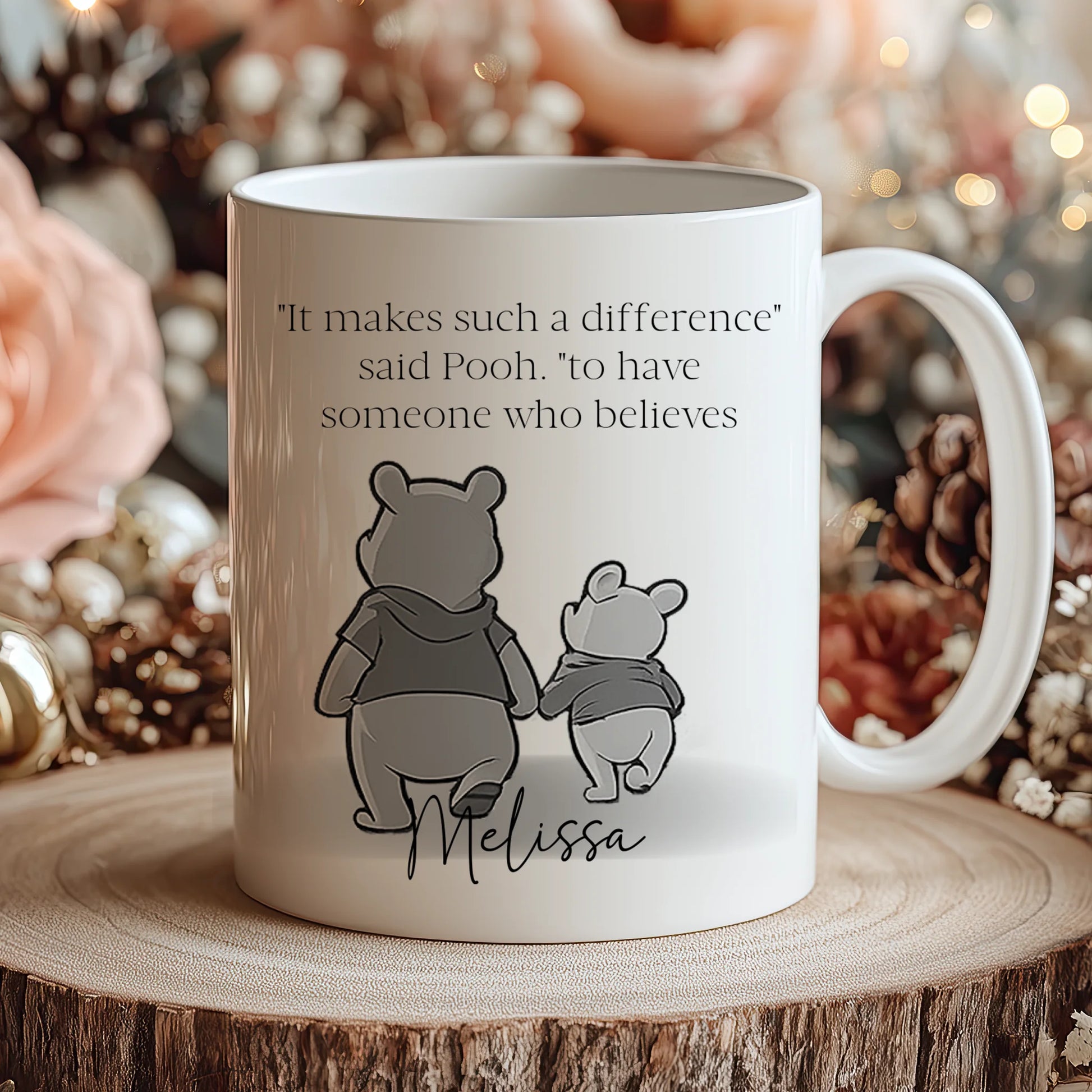 Mug with Winnie the Pooh design and text on a wooden surface with decorative background