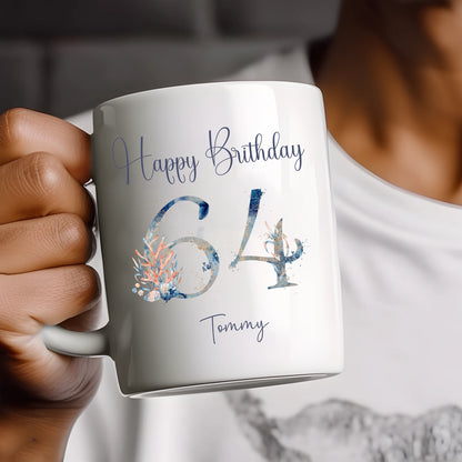 Person holding a mug with 'Happy Birthday 64 Tommy' text