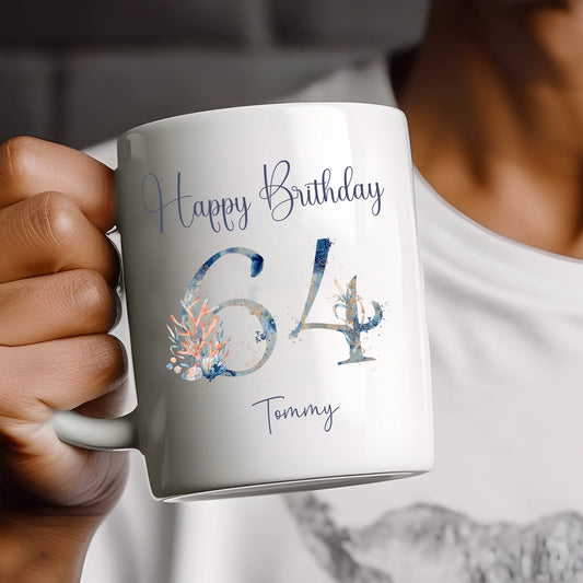 Person holding a mug with 'Happy Birthday 64 Tommy' text