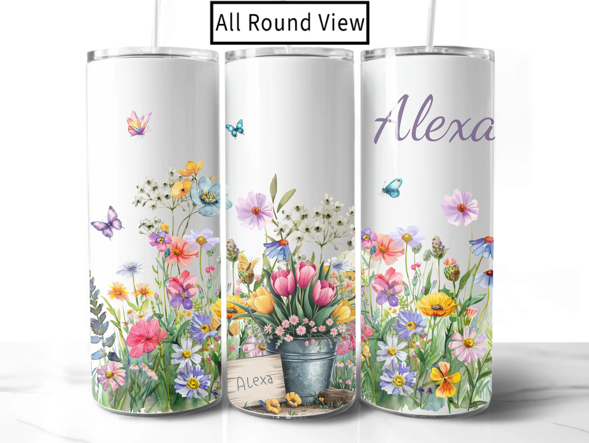 Three cylindrical tumblers with floral designs and names on a white background